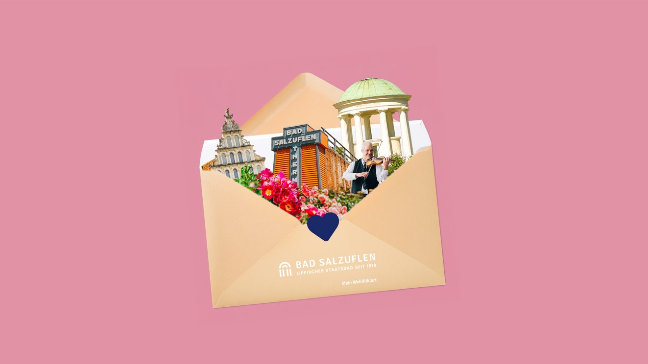 Auf rosa Hintergrund ein ge&ouml;ffneter Briefumschlag, aus dem verschiedene Bad Salzufler Wahrzeichen herausschauen