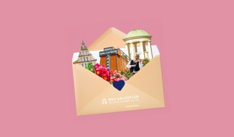 Auf rosa Hintergrund ein ge&ouml;ffneter Briefumschlag, aus dem verschiedene Bad Salzufler Wahrzeichen herausschauen